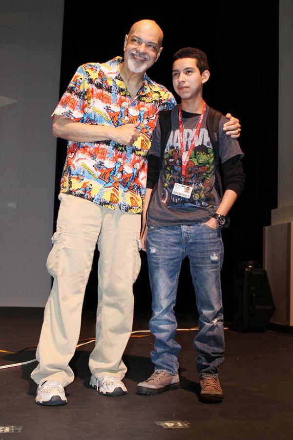 Visual arts student poses with George Perez after first talk back session.