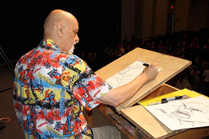 Perez sketches his beloved characters in front of the student audience before his talk back session.