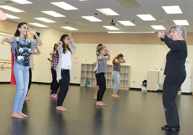 Perezs wife, Carol Flynn works with Bak students on the art of belly dancing