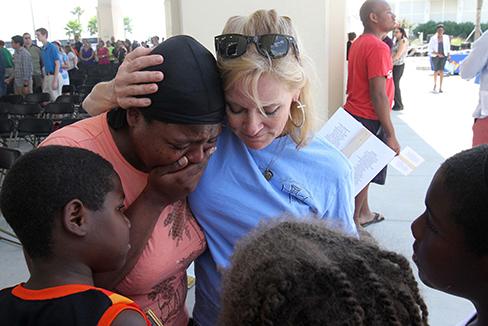 Anne Warren of Gulfport, Miss., right, prays with April Moore of Gulfport after the 10 Years, 10,000 Reasons Hurricane Katrina remembrance service at Barksdale Pavilion in Jones Park in Gulfport on Saturday, Aug. 29, 2015. Moore, who said she lost everything in Katrina, was overcome by memories of the storm. (John Fitzhugh/Biloxi Sun Herald/TNS)