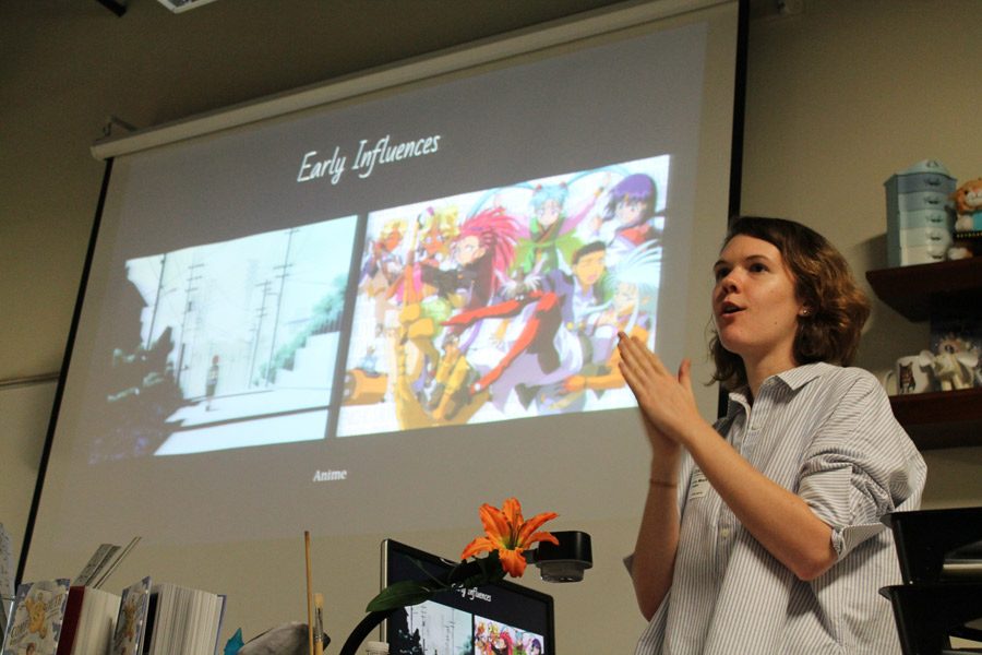 Smiling, Rebecca Mock shows students her influences early in her career.  She gave students ideas on how to develop their own individual styles as artists, and how to work past any obstacles. “She kept on telling us to keep trying. Even if you present work to someone who rejects it, eventually someone will take it,” Sydney Williams, eighth grade visual major said.
