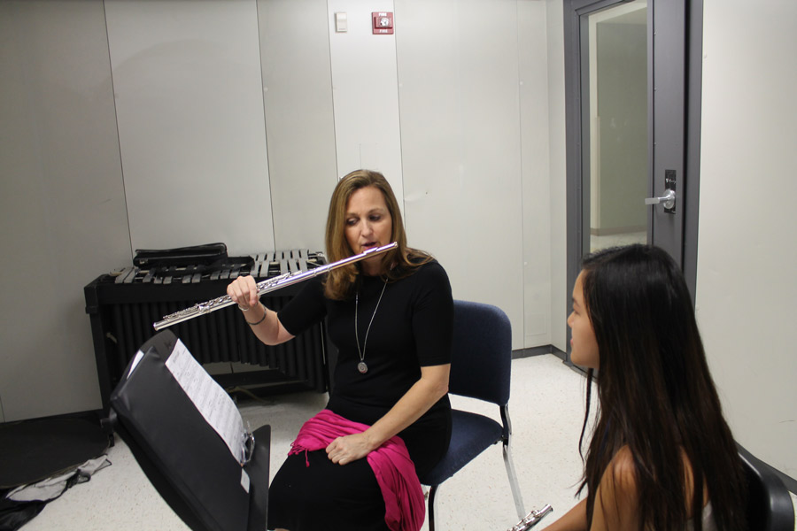 Artist in residence, Karen Dixon, helps students who play the flute during their band class. The MSOA Foundation paid for Dixon to tutor these students.