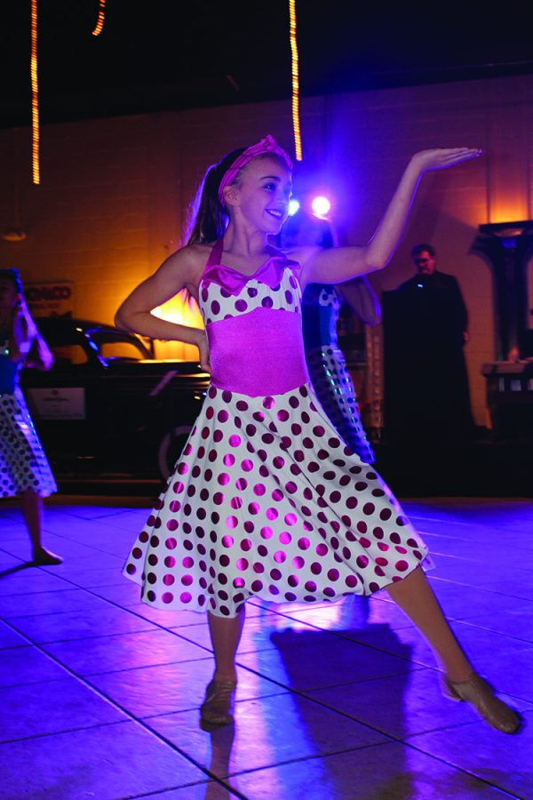 Morgan Riley, seventh grade dance major, pretends to hold a platter in a dance number at the Stroke of Genius event. Dance showcased their talent by performing a “diner-themed” routine. 