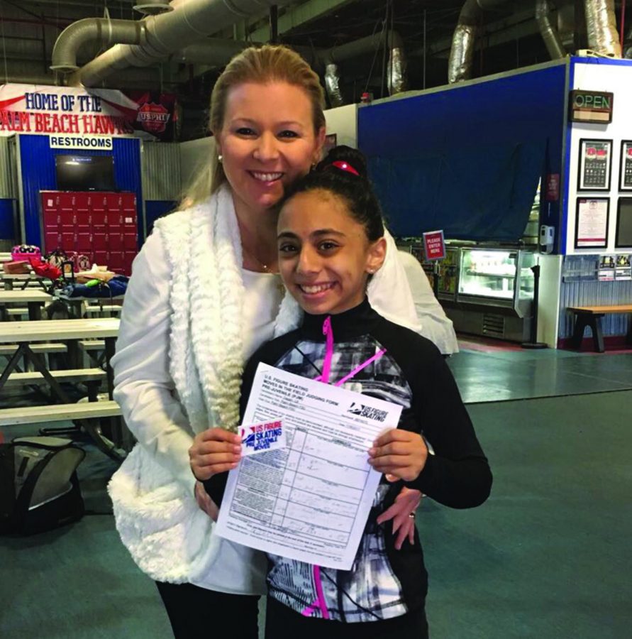 Lili Dagan, seventh grade piano major, poses with Audra Leech, her coach, and the results of a skating test. “My most recent test was about my free juvenile moves, which are moves that are about the middle point in difficulty,” Dagan said. 