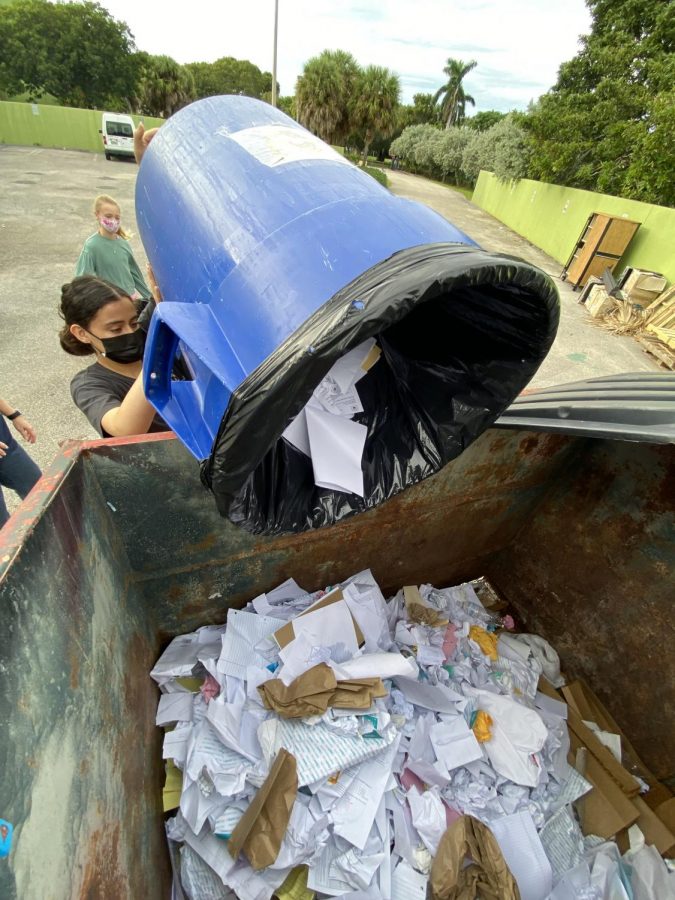 Dumping paper into the school recycling bin, eighth grade theater major Karina Brown helps the school become more environmentally conscious.  Bejarano said, “We collect paper and cardboard, and then we also are doing a cleanup of the grounds.” 