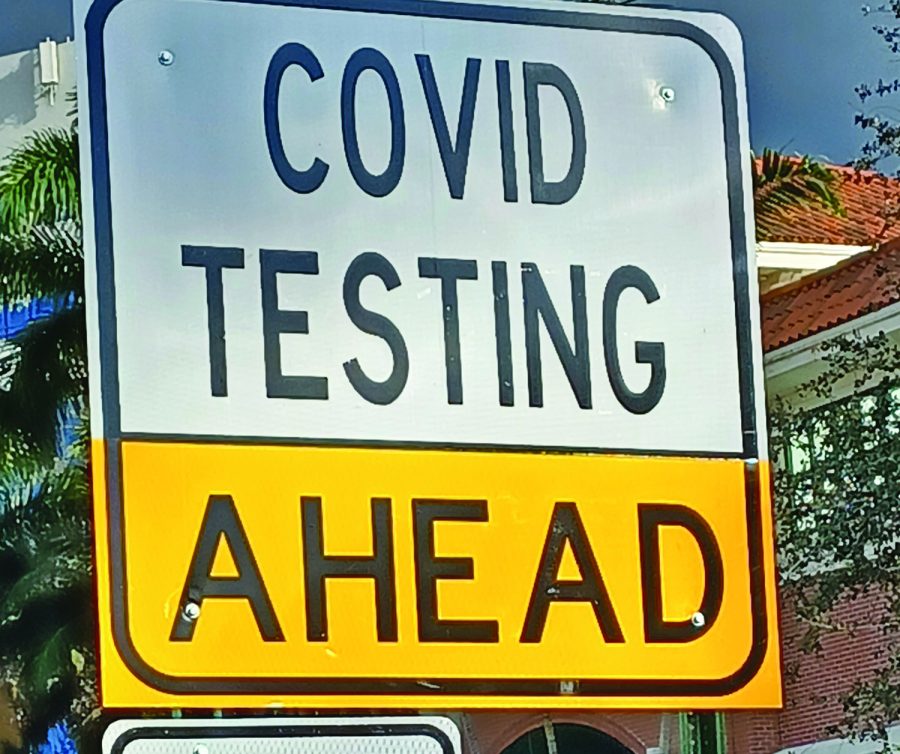 A sign in Palm Beach Gardens directs people to a drive-thru testing site. “Everyone plays a part in trying to stay safe and I hope we won’t have to deal with COVID-19 next school year,” Timothy Regula, assistant principal, said.