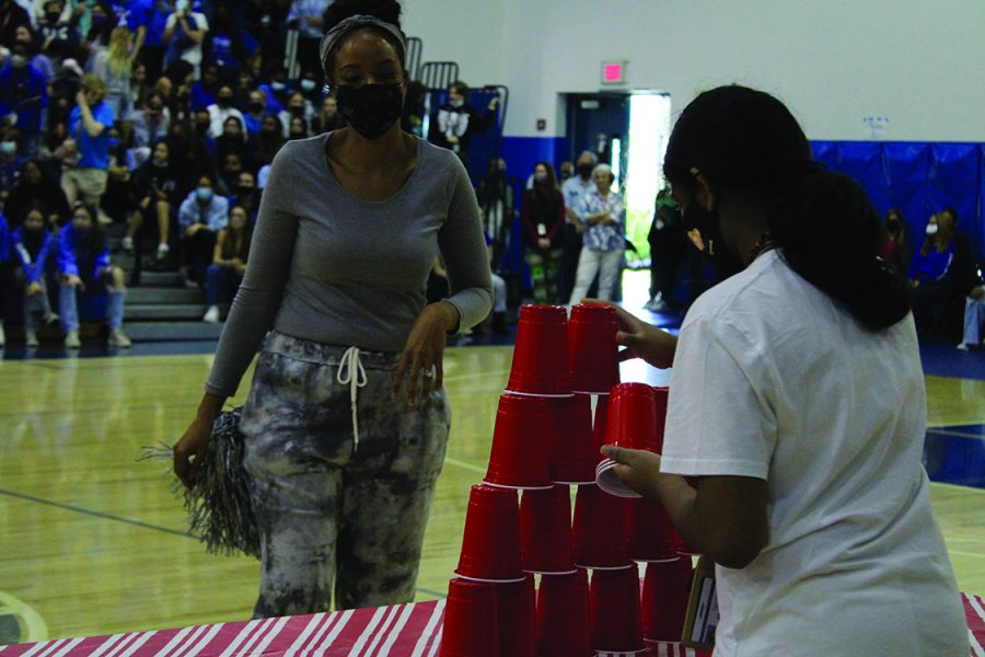Sixth grade communications major Rucha Shah builds a cup pyramid during the cup stacking game. “It was nerve-racking since my hands were so shaky. I kept knocking the cups over,” Shah said. 