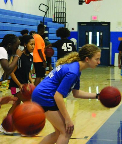 Participating in a drill, Samantha Ellis (8), Mackenzie Charles (7), and Raina Caballero (7), face off against players. “Each players skills help us improve,” Charles said. 